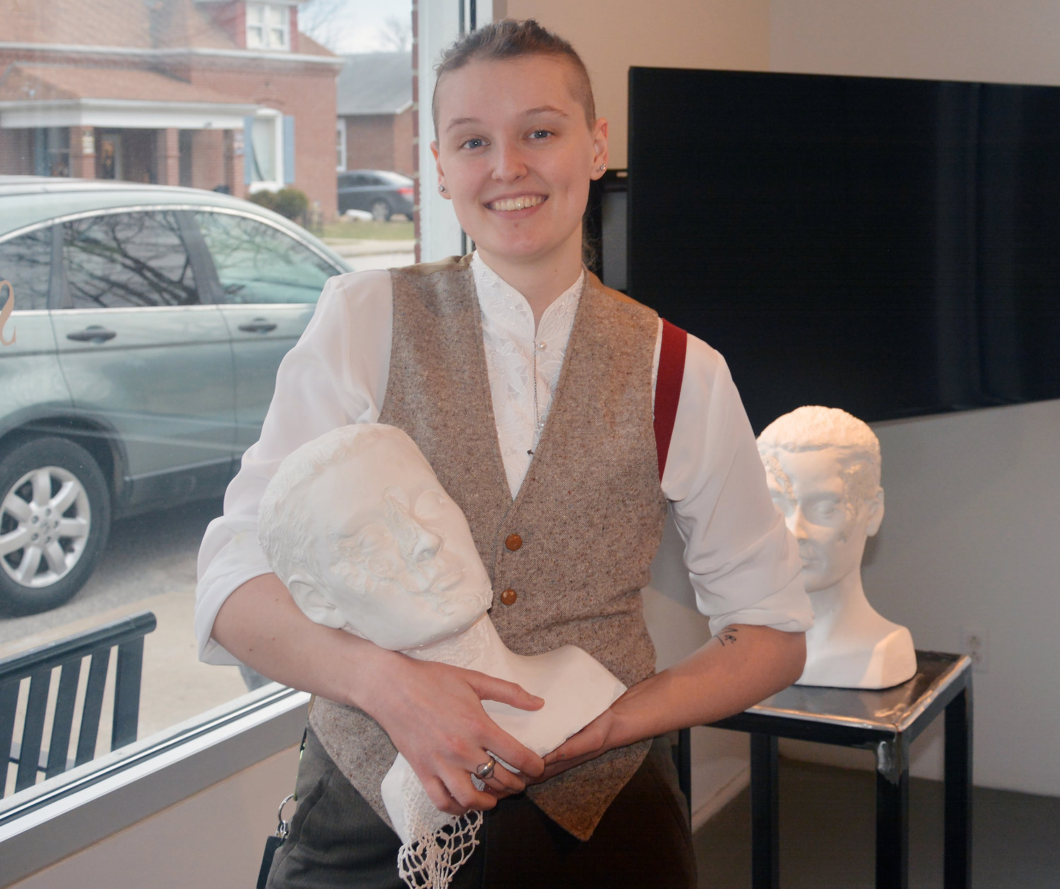Artist Maggie Adams poses with a plaster sculpt of her head at the Osage Arts Community Art Center. Adams finished an OAC residency last fall.